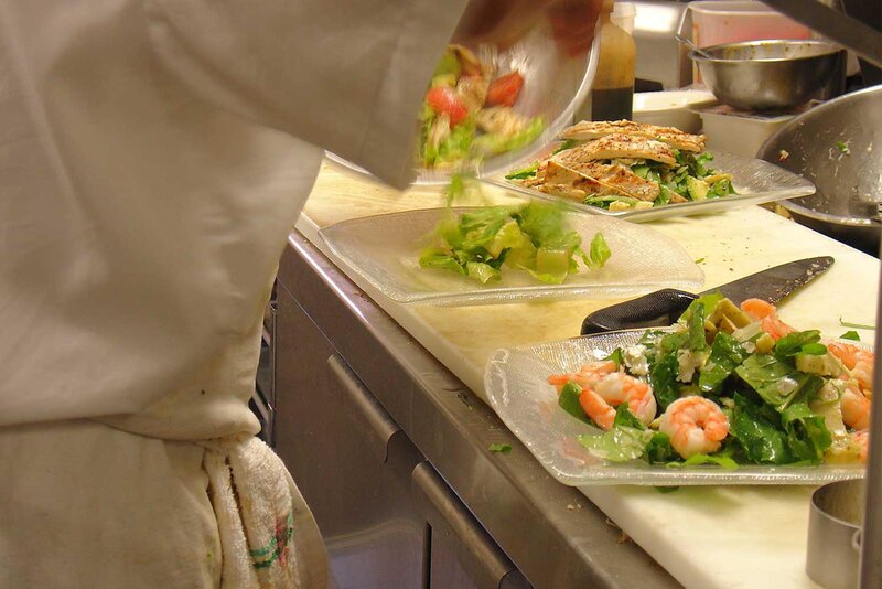 Chef preparing multiple salads