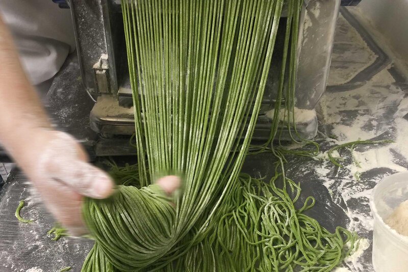 Fresh pasta coming out of a pasta maker