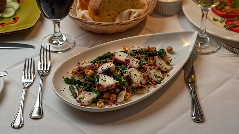 Salad topped with sliced octopus